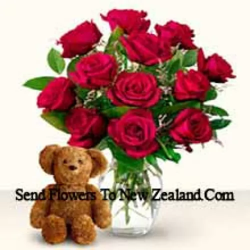 11 Red Roses With Some Ferns In A Glass Vase Along With A Cute 12 Inches Tall Brown Teddy Bear